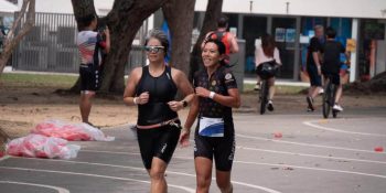 Delia Kang (left) running with her triathlon guide Jaynelle Lee (right)